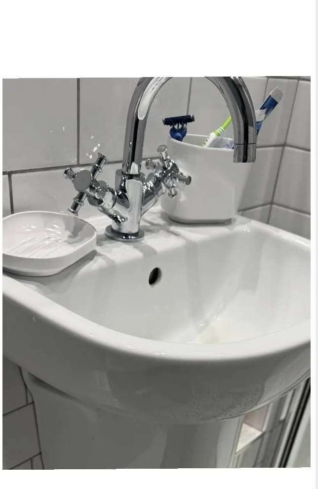 Sparkling chrome bathroom tap and pedestal basin after limescale removal by True Grit Cleaning Co in North Yorkshire