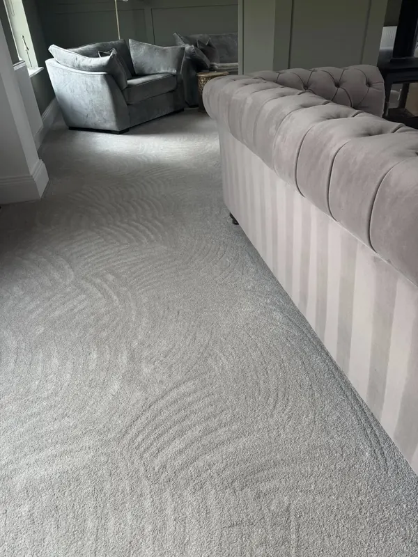 Grey living room carpet with fresh hoover lines beside a chesterfield sofa, cleaned by True Grit Cleaning Co in Darlington