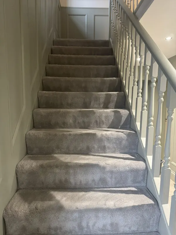 Grey stair carpet with white spindle banister cleaned and freshly hoovered by True Grit Cleaning Co in the Yorkshire Dales